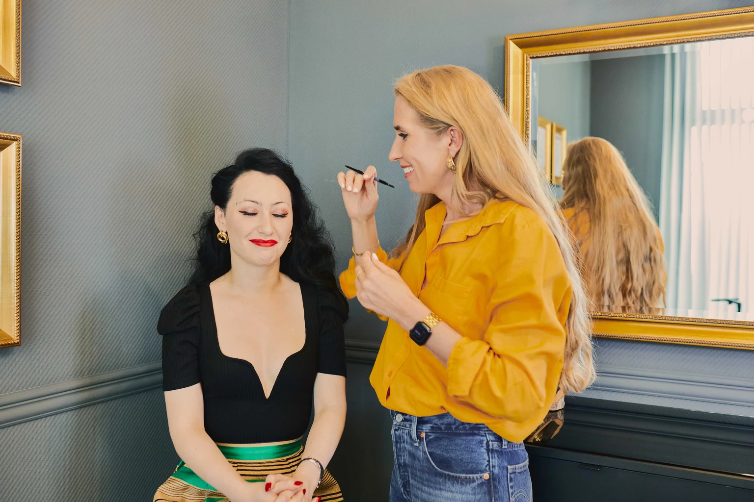 Olga Keller consulting and mapping a client’s eyebrows